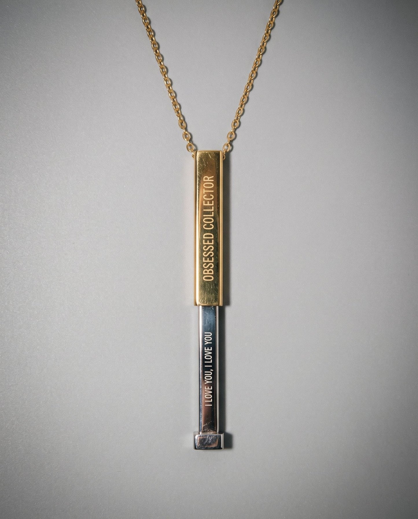Two-tone gold and silver sliding necklace revealing hidden 'I LOVE YOU' message