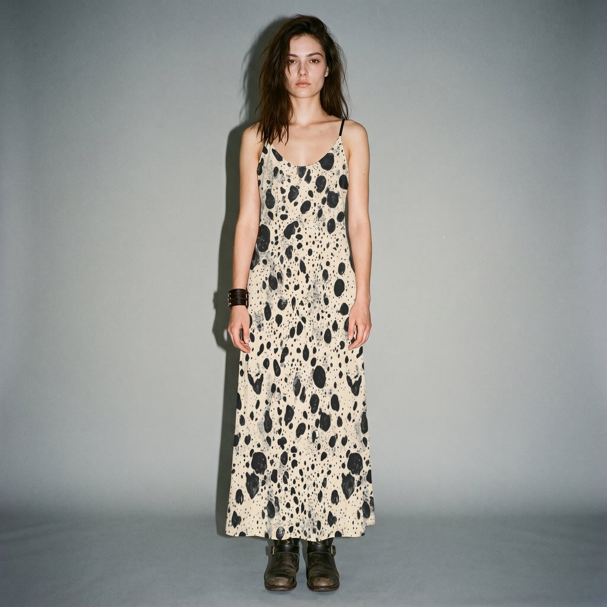 Model wearing cream speckled long sleeveless dress with side pockets