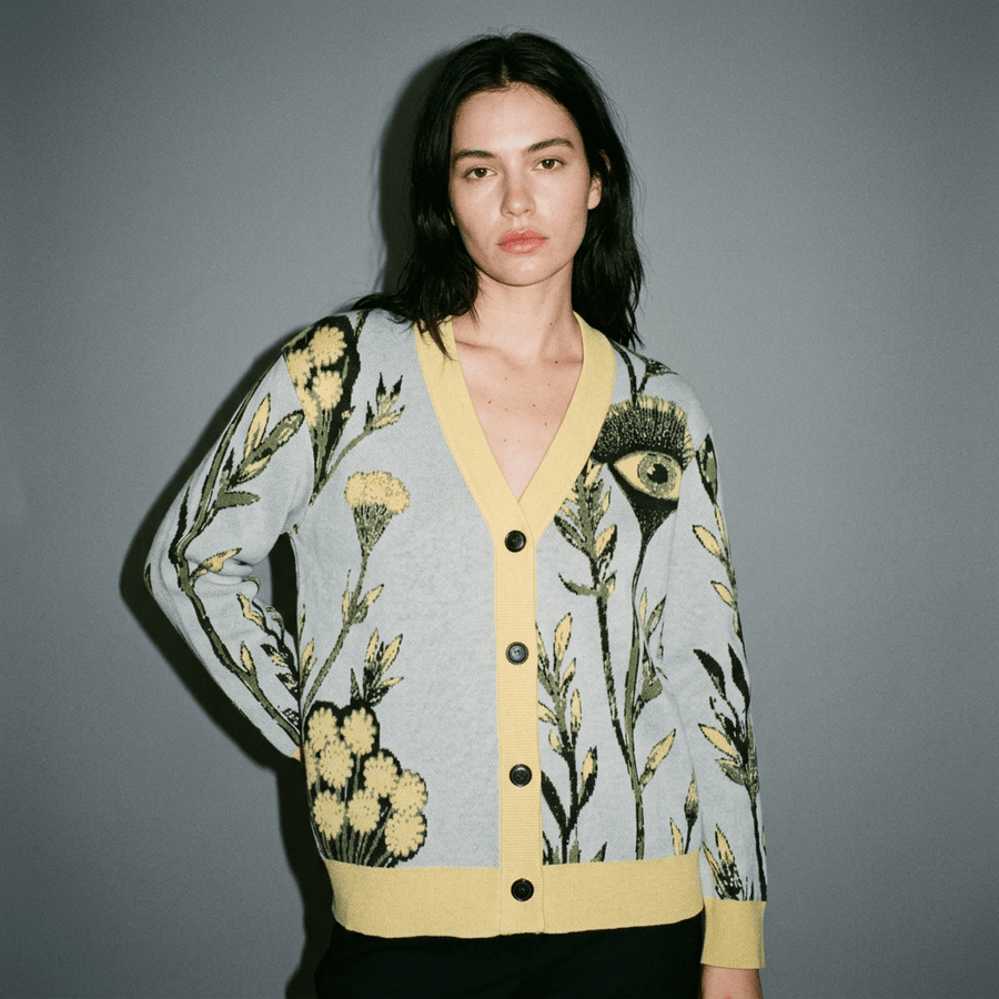 Buttoned powder blue cardigan with full botanical print and eye motif