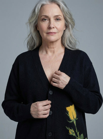 Black V-neck cardigan with knitted yellow rose detail on front