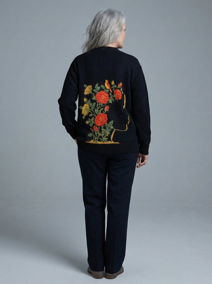 Model wearing black cardigan with large back graphic of silhouette and flowers