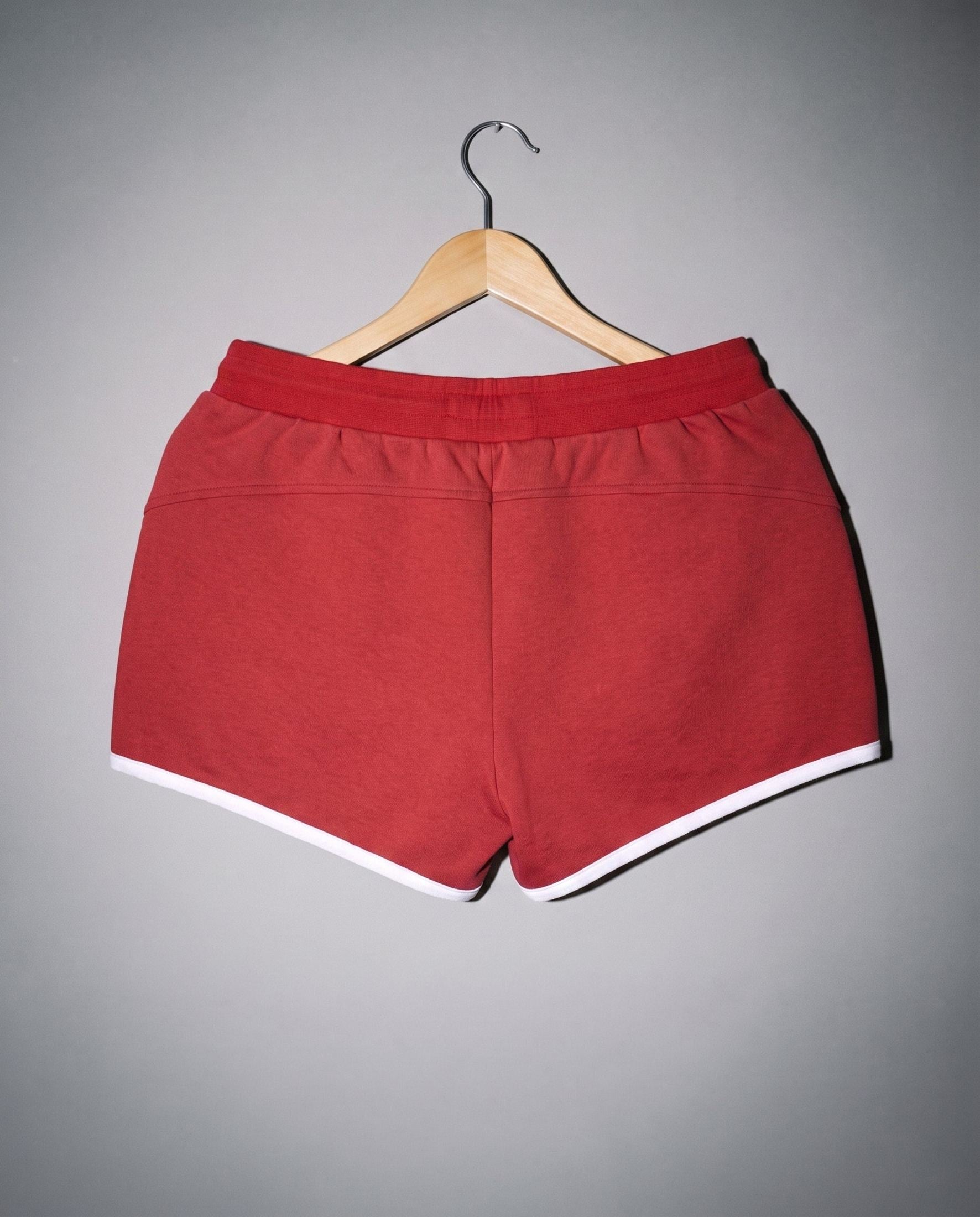 Red soft stretch shorts with ribbed elastic waist and white hem trim back view