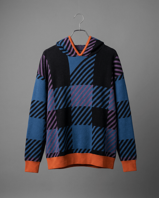 Front detail of black and blue tartan knit hoodie with burnt orange ribbed trim on hanger
