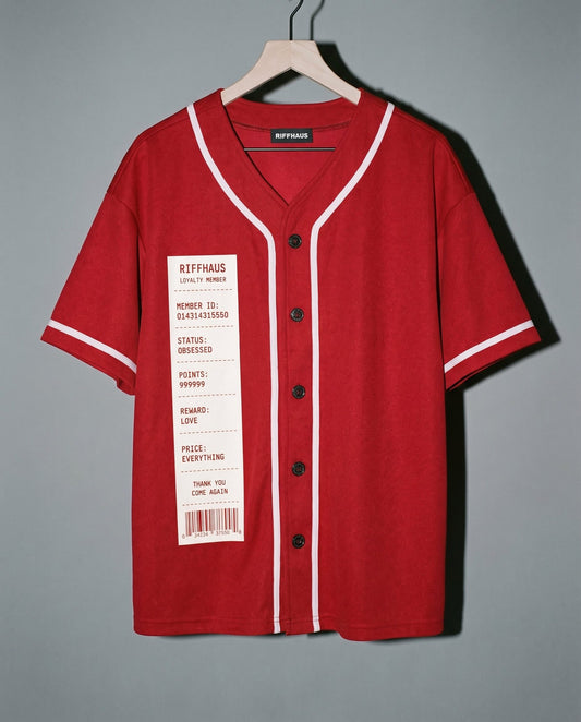 Red V-neck short sleeve button up shirt featuring receipt style loyalty tag and white piping