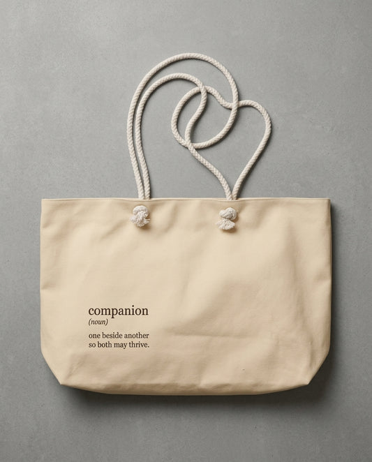 Cream tote bag with rope handles and companion definition print