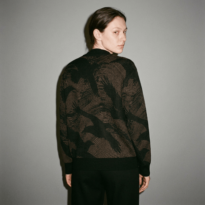 Back view of unisex knit cardigan with crow silhouette print and black rib trim