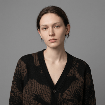 Close-up of knit cardigan fabric texture and detailed crow silhouette pattern