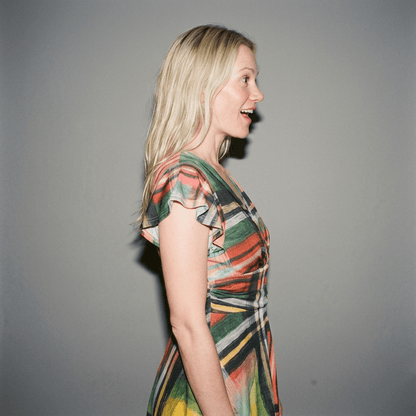 Side view of plaid midi dress showing fluid drape and gathered waist