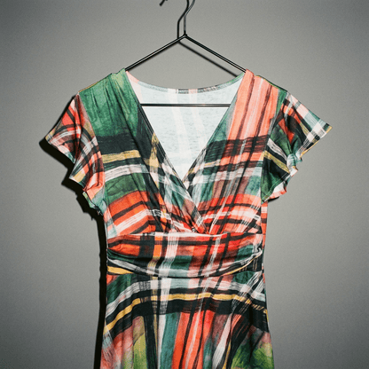 Close up of painterly plaid flutter sleeve dress V-neckline detail