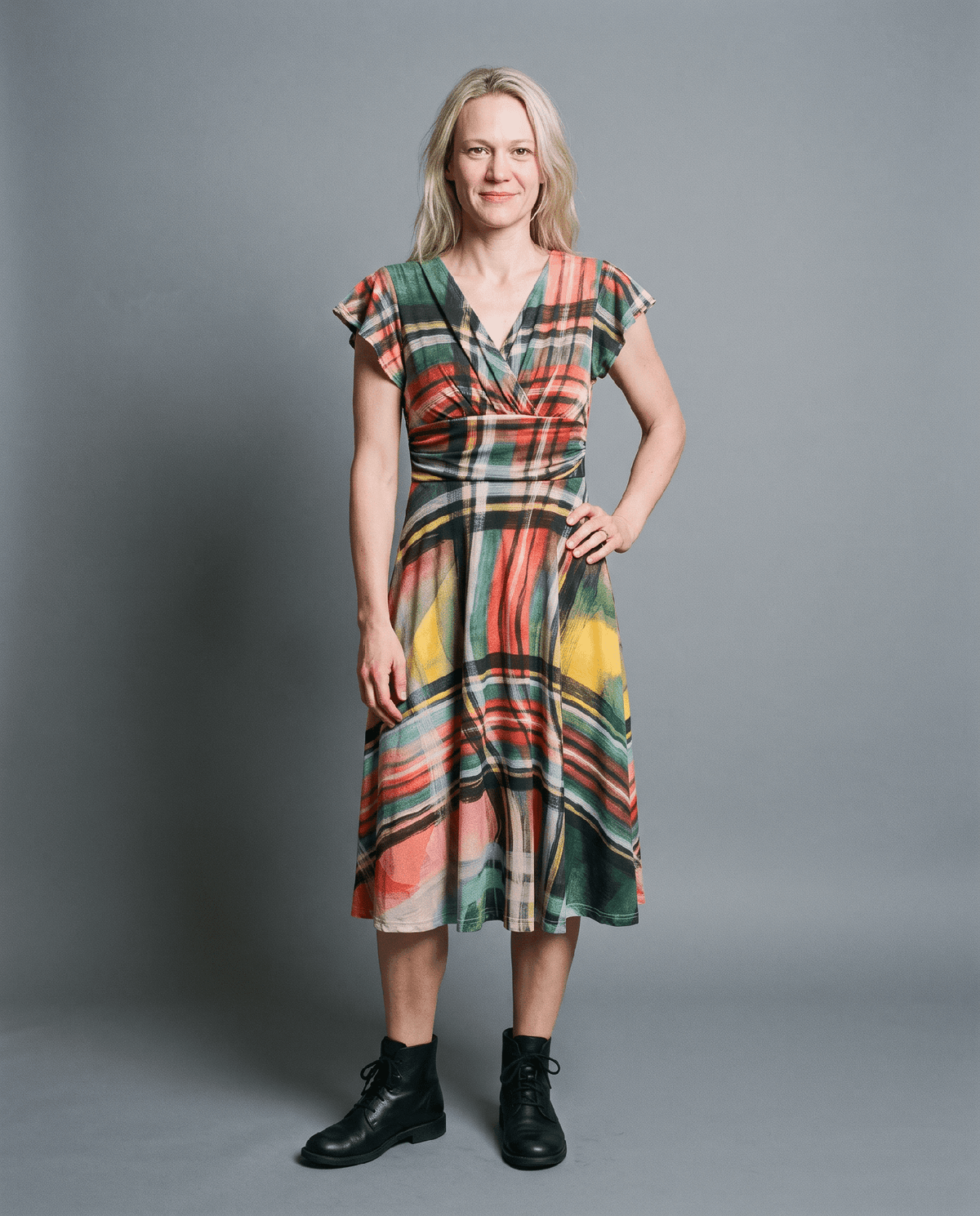 Green orange plaid midi dress with flutter sleeves and V-neck on model