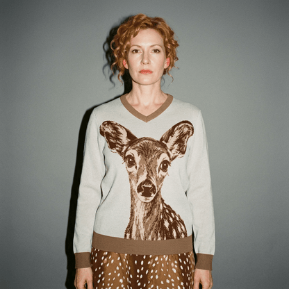 Model wearing powder blue fawn print V-neck sweater styled with spotted skirt