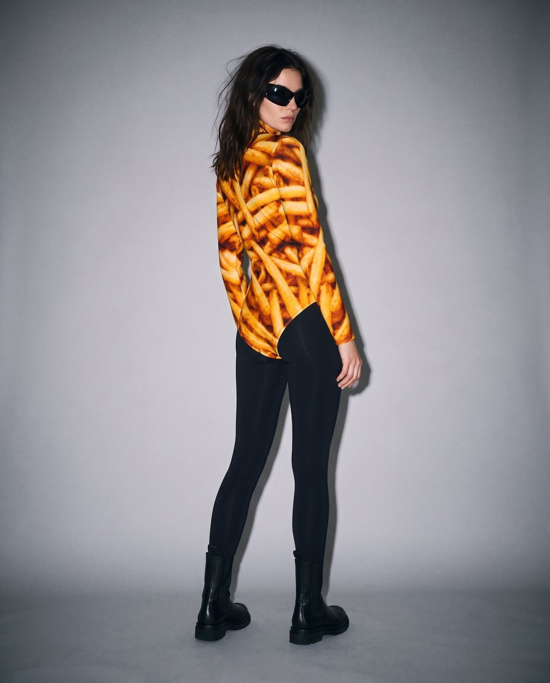 Side fit of french fry print scuba fabric bodysuit on model