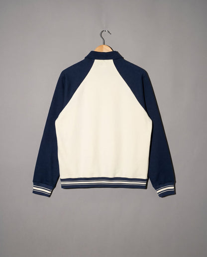 Cream and navy varsity jacket back view with ribbed cuffs