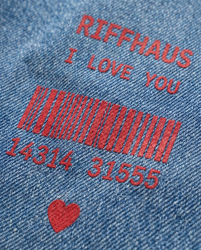 Close-up of Riffhaus I LOVE YOU red graphic print on blue denim