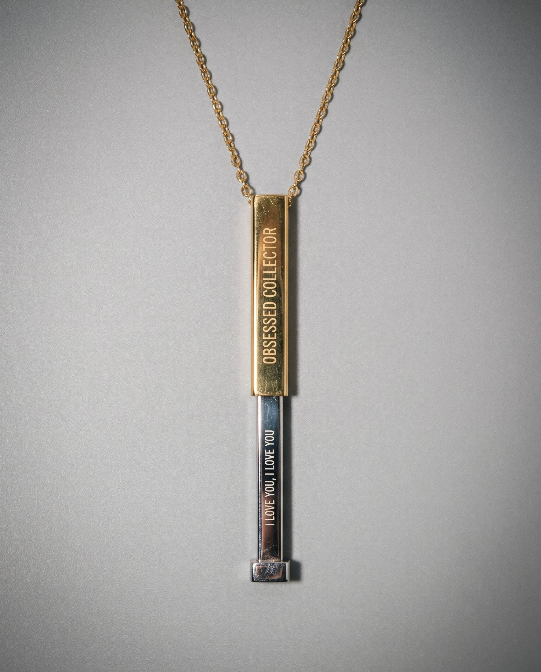 Two-tone gold and silver sliding necklace revealing hidden 'I LOVE YOU' message
