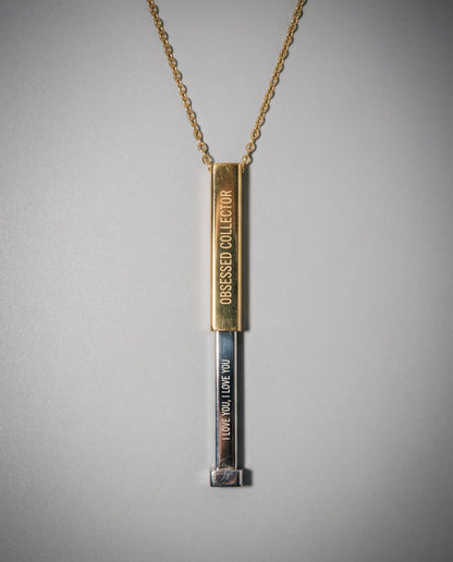 Two-tone gold and silver sliding necklace revealing hidden 'I LOVE YOU' message