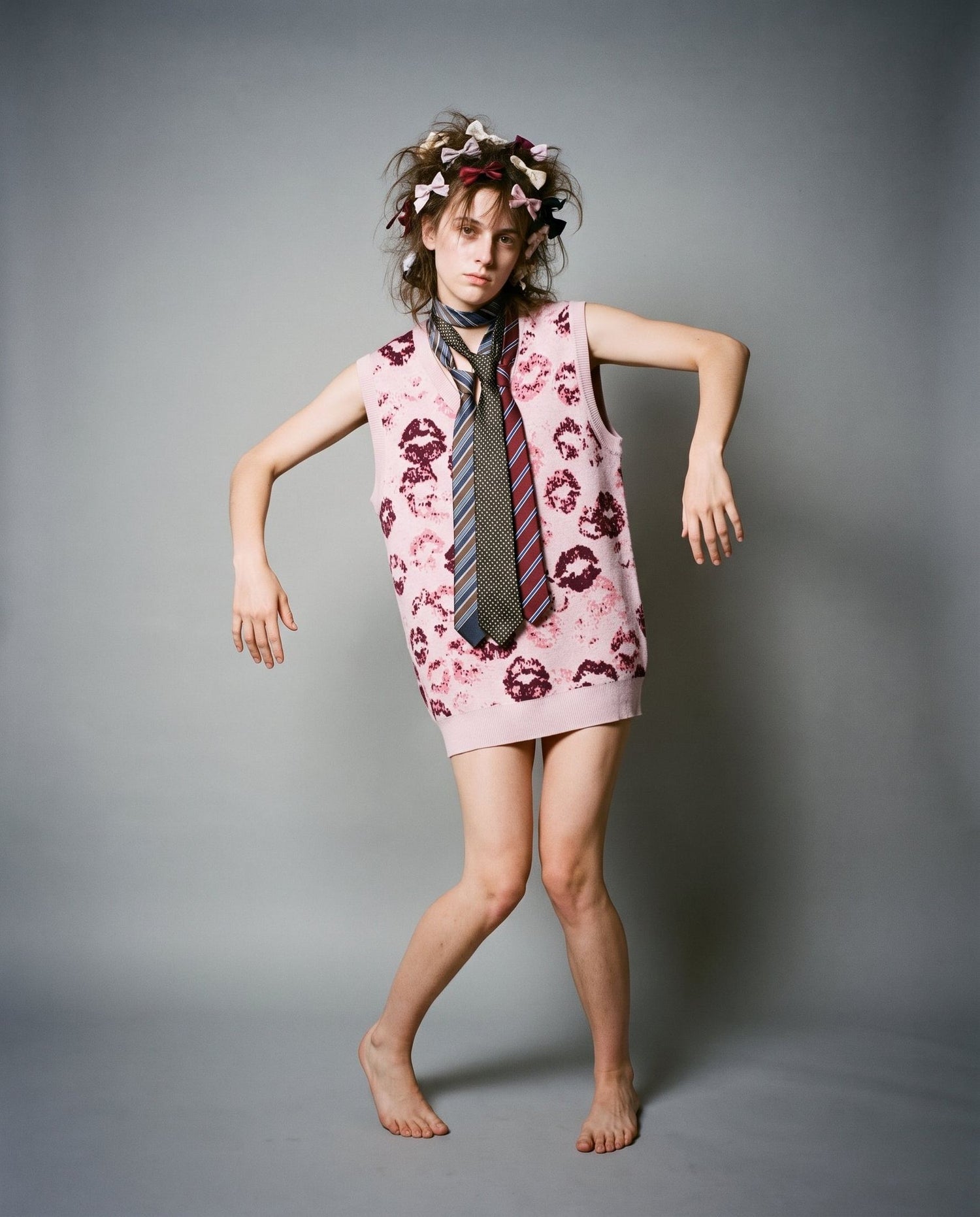 Graphic kiss-print vest worn as mini dress with multi-patterned tie