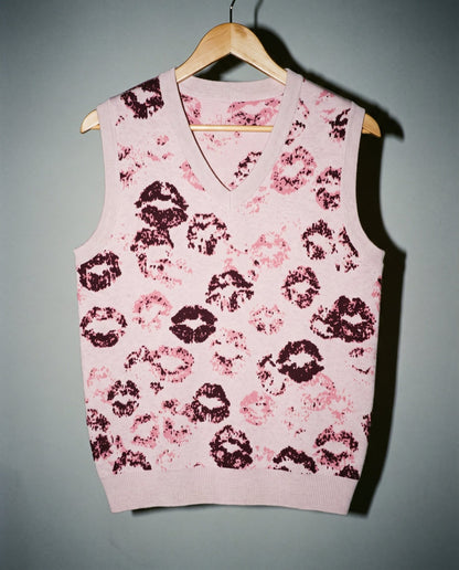 Light pink V-neck vest featuring graphic overlapping kiss marks