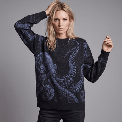 Woman wearing Riffhaus KRAKEN dark heathered knit sweater featuring soft blue octopus design