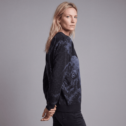 Side view of woman wearing Riffhaus KRAKEN dark heathered knit sweater showing octopus tentacle detail