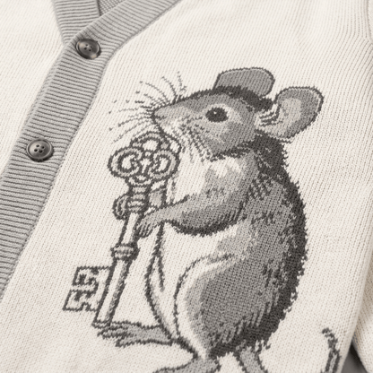 Cream jacquard knit cardigan detail: gray mouse holding skeleton key near ribbed placket