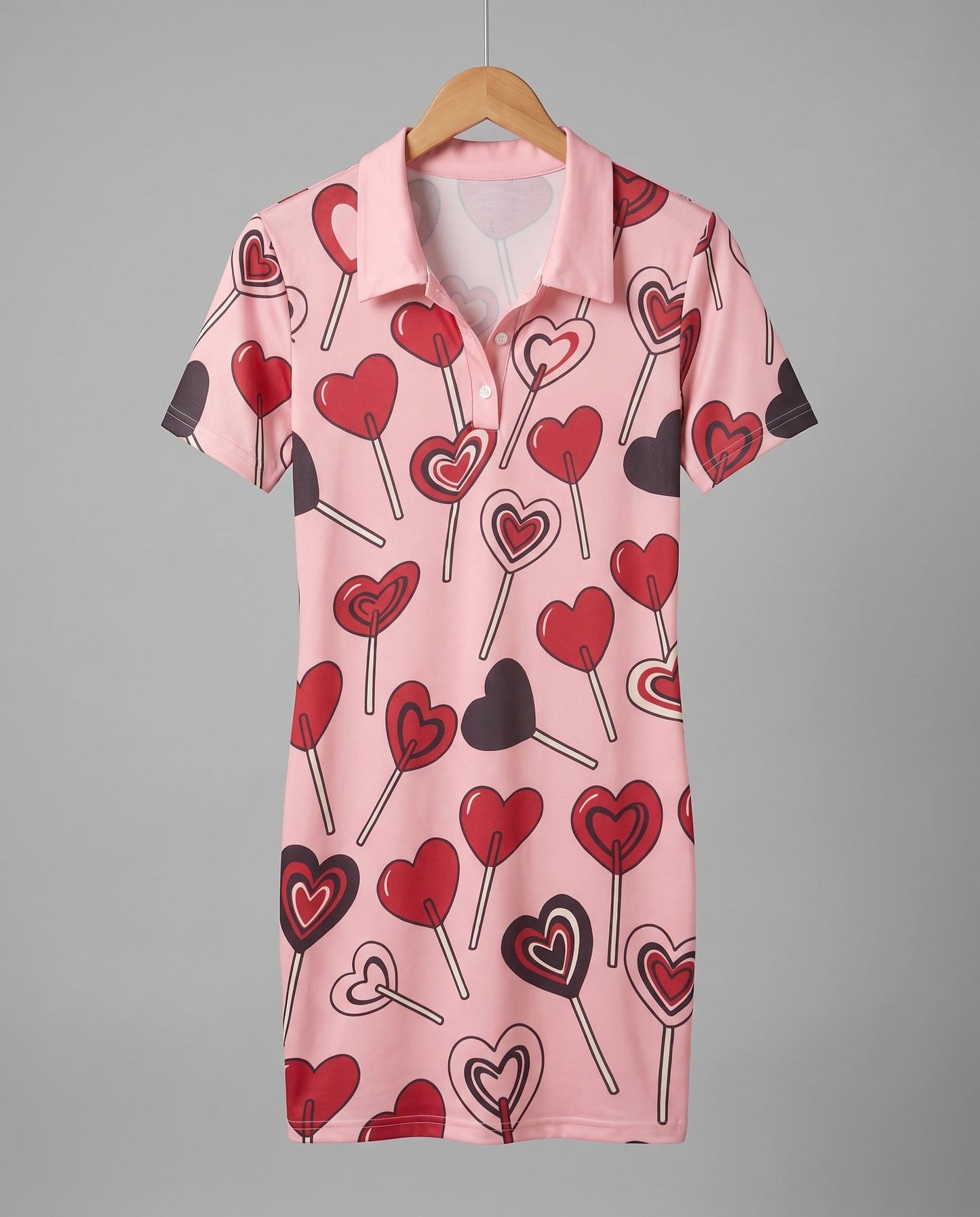 Pink short sleeve polo dress with red and black lollipop print front
