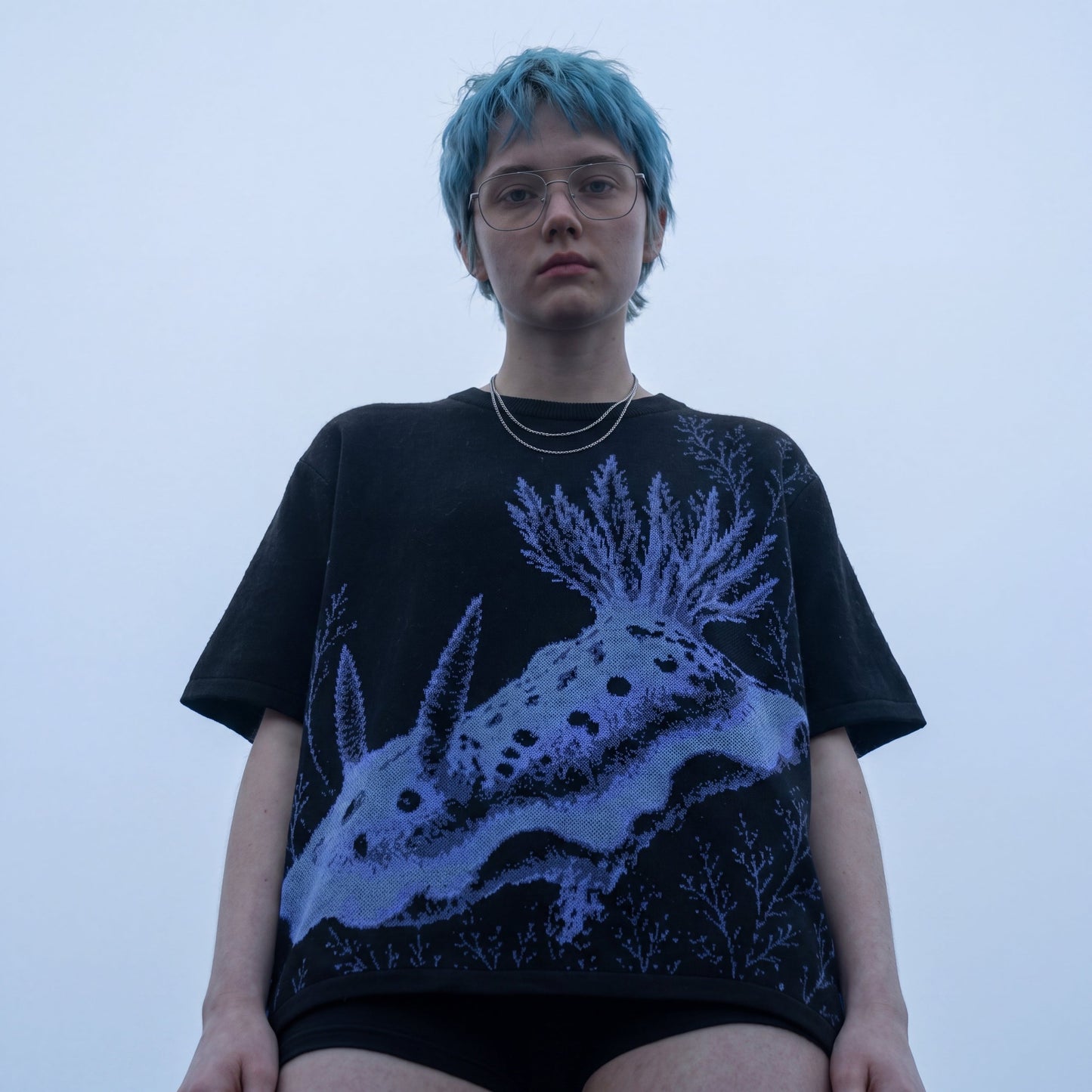 Black nudibranch knit t-shirt with blue and purple sea creature graphic