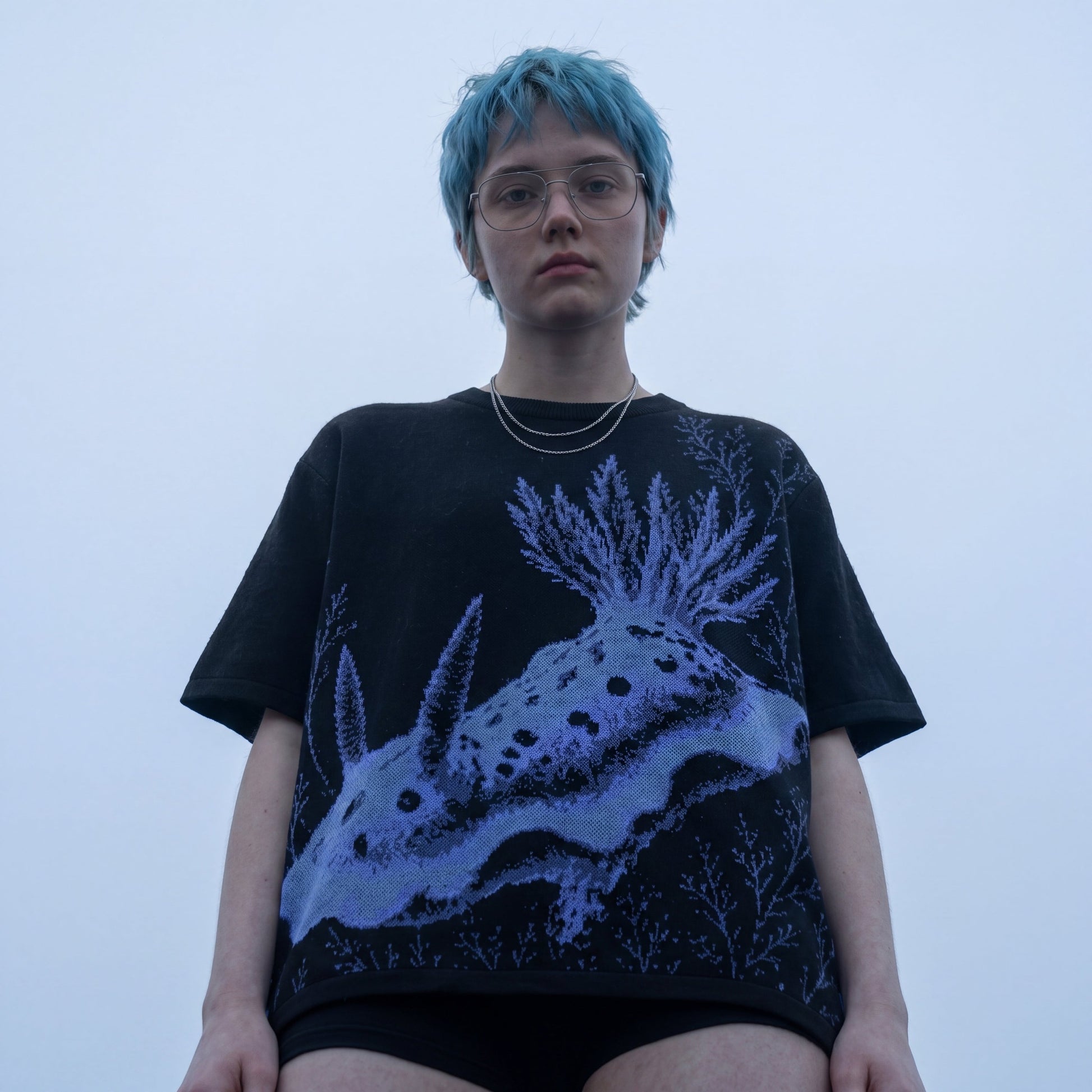 Black nudibranch knit t-shirt with blue and purple sea creature graphic