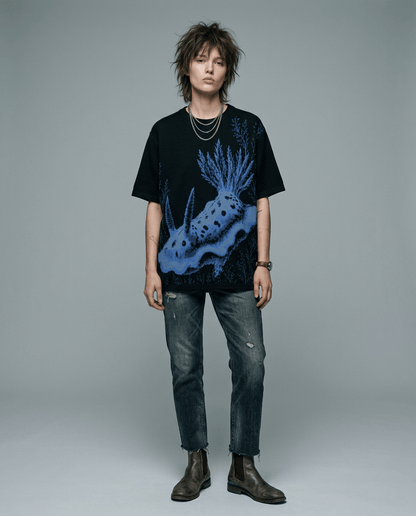 Oversized black nudibranch knit t-shirt worn by model with ripped jeans
