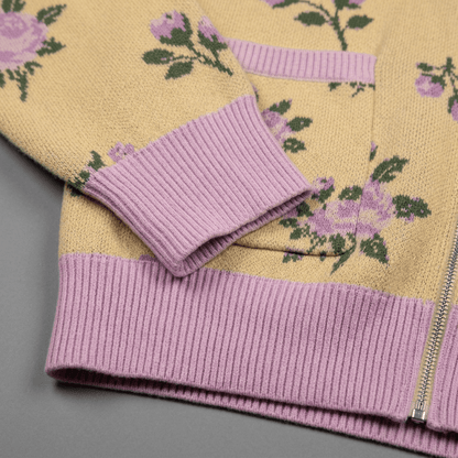 Detail shot of pink ribbed cuff and yellow fabric with rose jacquard