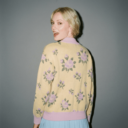 Back view of yellow knit bomber displaying continuous rose leaf motif