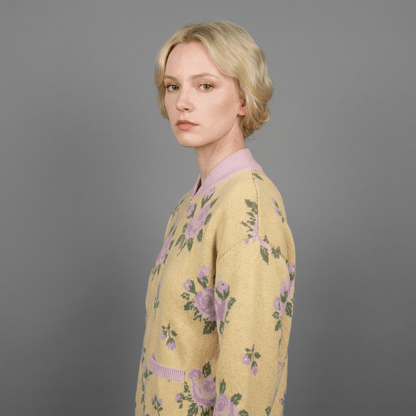Side view of yellow floral knit bomber showing ribbed cuffs and collar