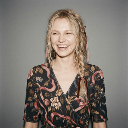 Close-up of black wrap dress v-neck and braid detail