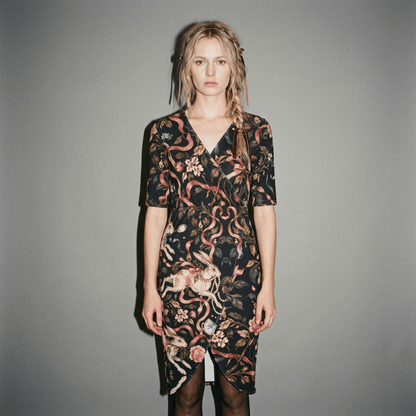 Model wearing black wrap dress with rabbit print and tights