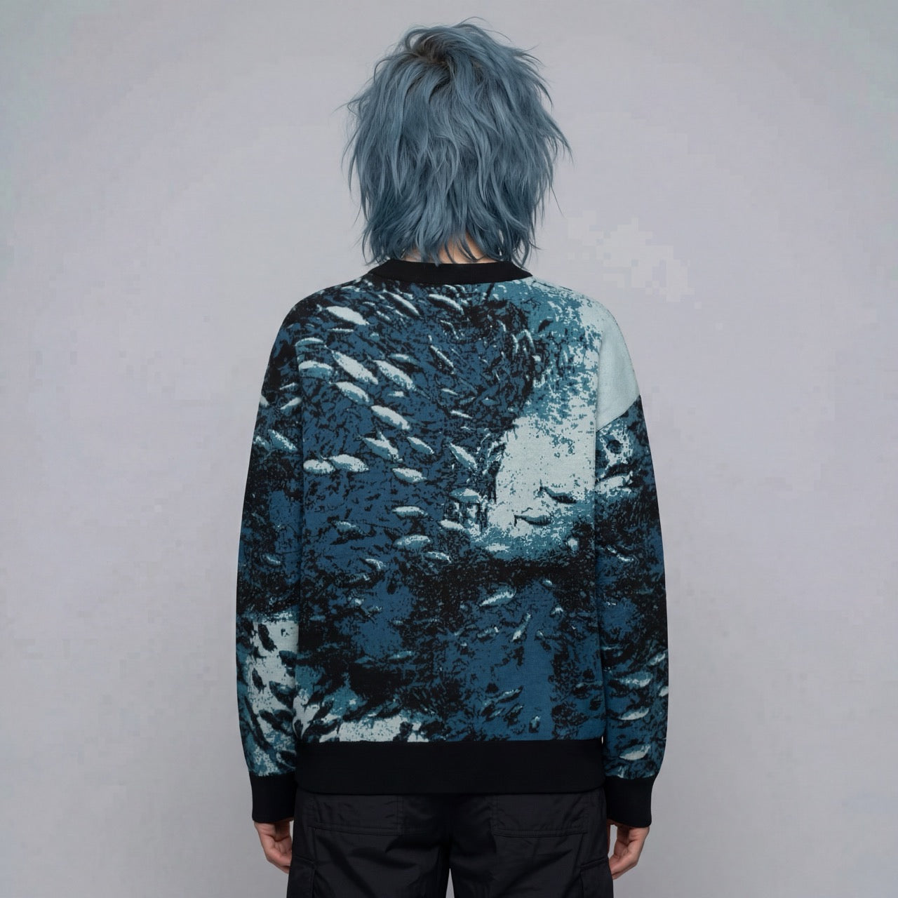 Back view of model in Riffhaus Sardine School sweater showing seamless sardine school pattern flow