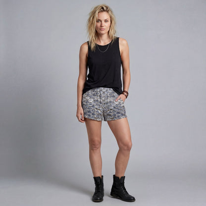 Women's SCALES mid-thigh shorts with scale pattern styled with black top and boots