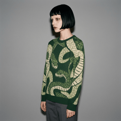 Dark green jacquard knit sweater with cream snake pattern on model