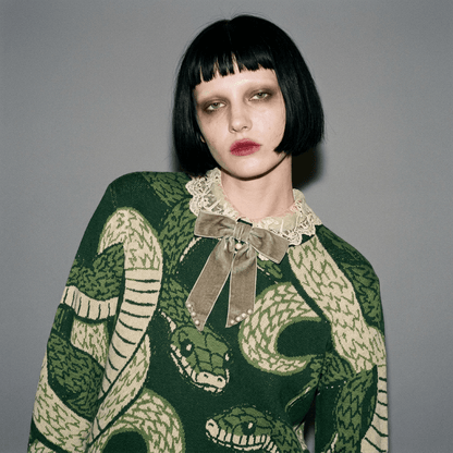 Close up of dark green snake jacquard sweater neck detail and lace collar