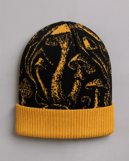 Black knit beanie with golden mushroom pattern and ribbed cuff