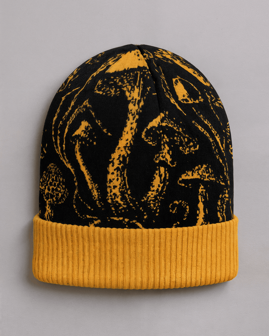 Black knit beanie with golden mushroom pattern and ribbed cuff