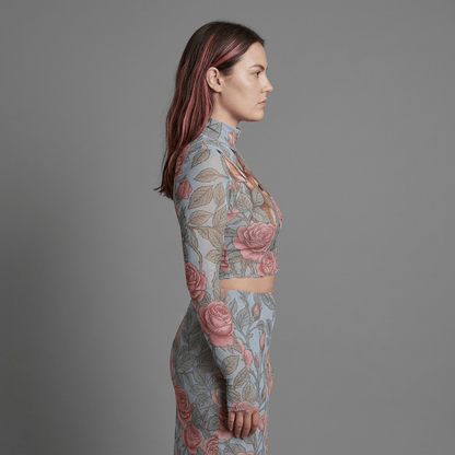 Side profile of model in powder-blue mesh two-piece outfit