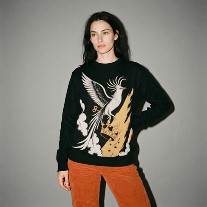 Model wearing black unisex knit sweater with integrated bird and crown graphic