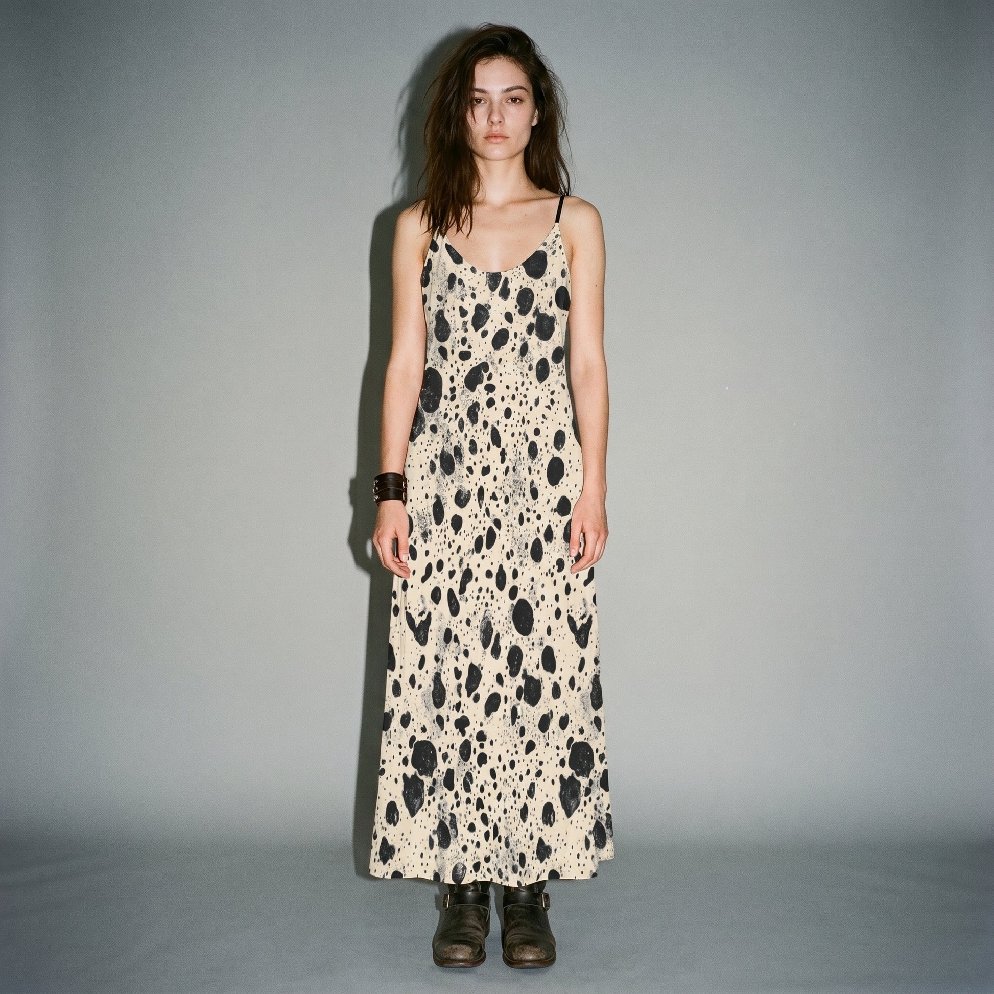 Model wearing cream speckled long sleeveless dress with side pockets