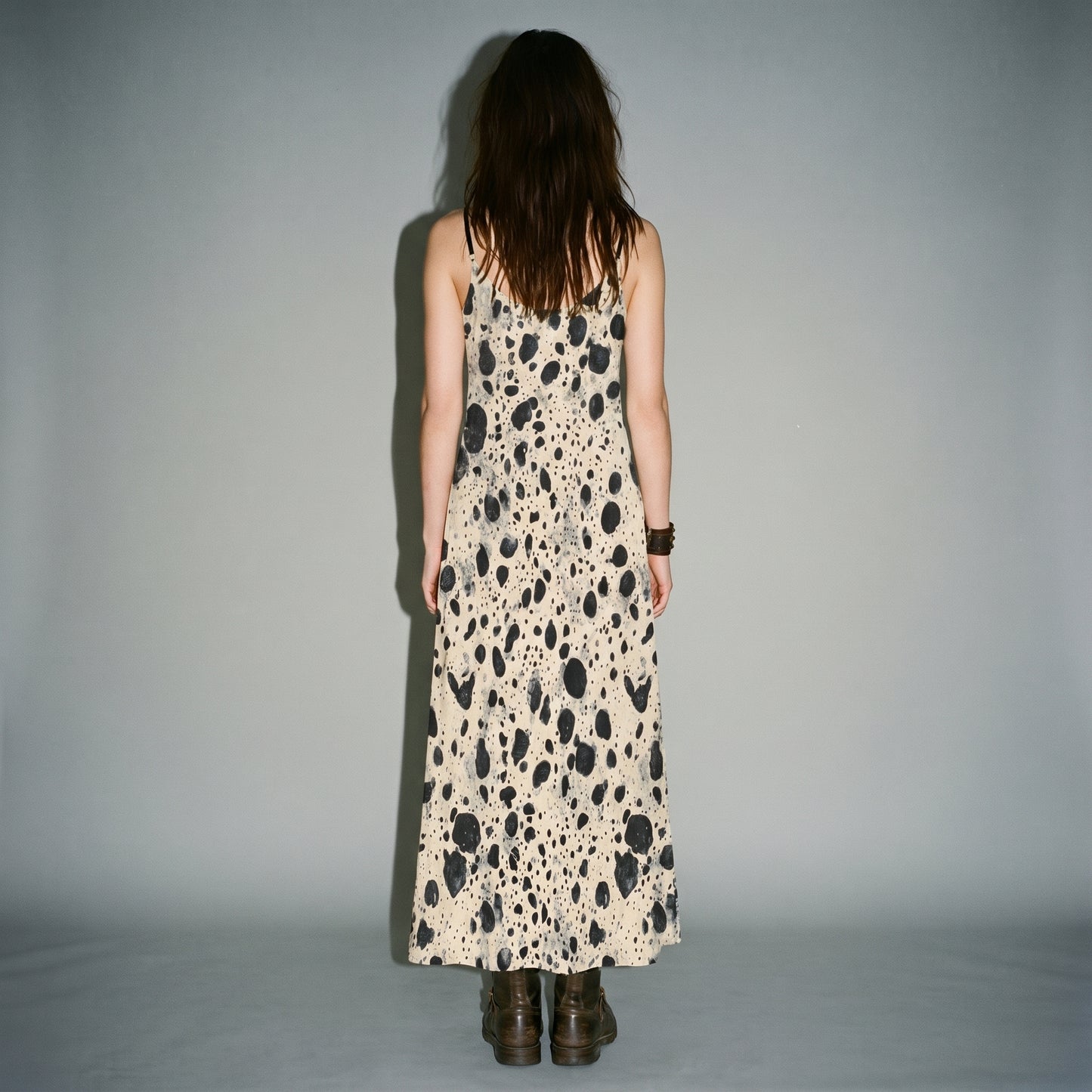 Rear view of smooth fit on cream speckled A-line sling dress