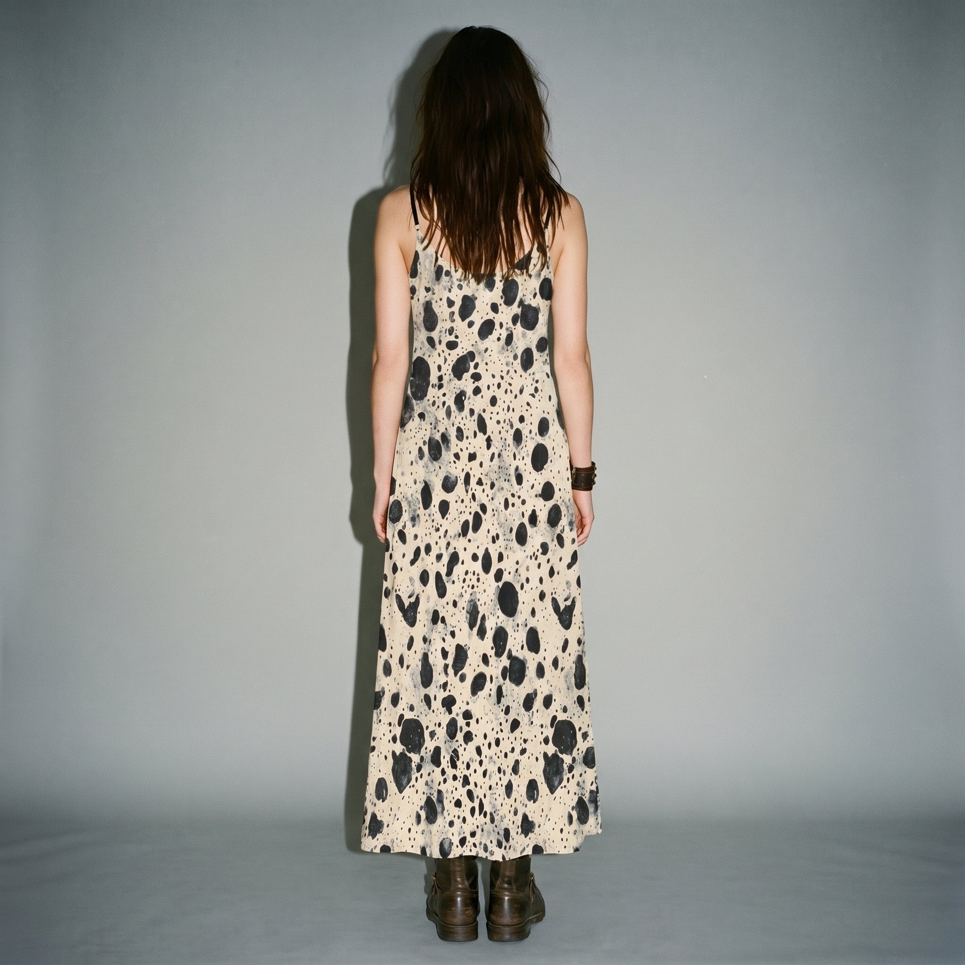 Rear view of smooth fit on cream speckled A-line sling dress