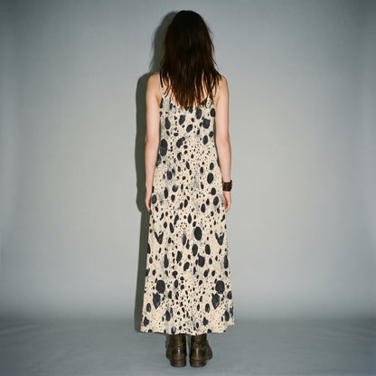 Rear view of smooth fit on cream speckled A-line sling dress