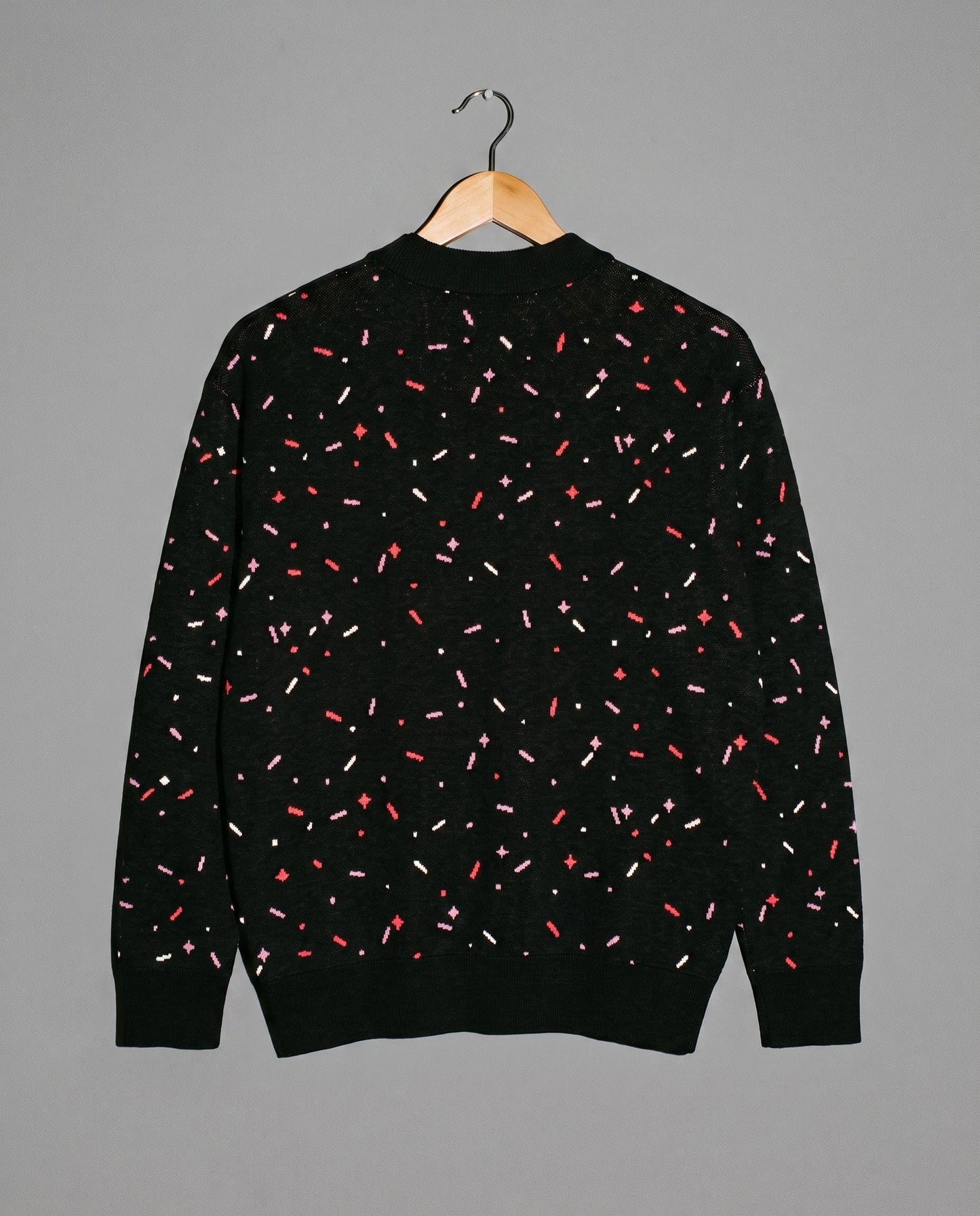Back view of black confetti pattern knit cardigan with ribbed trim