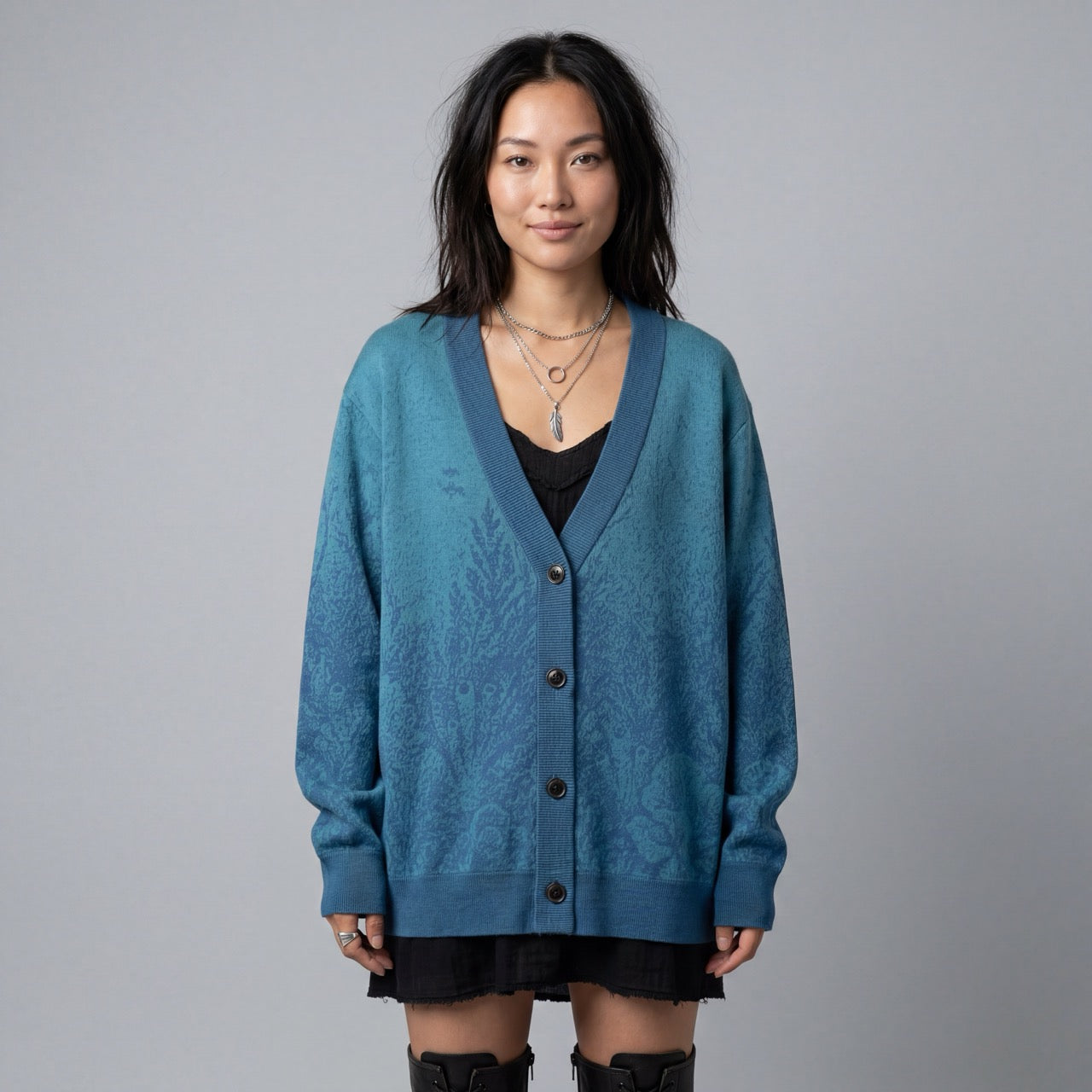 Model wearing blue V-neck cardigan with organic submerged print