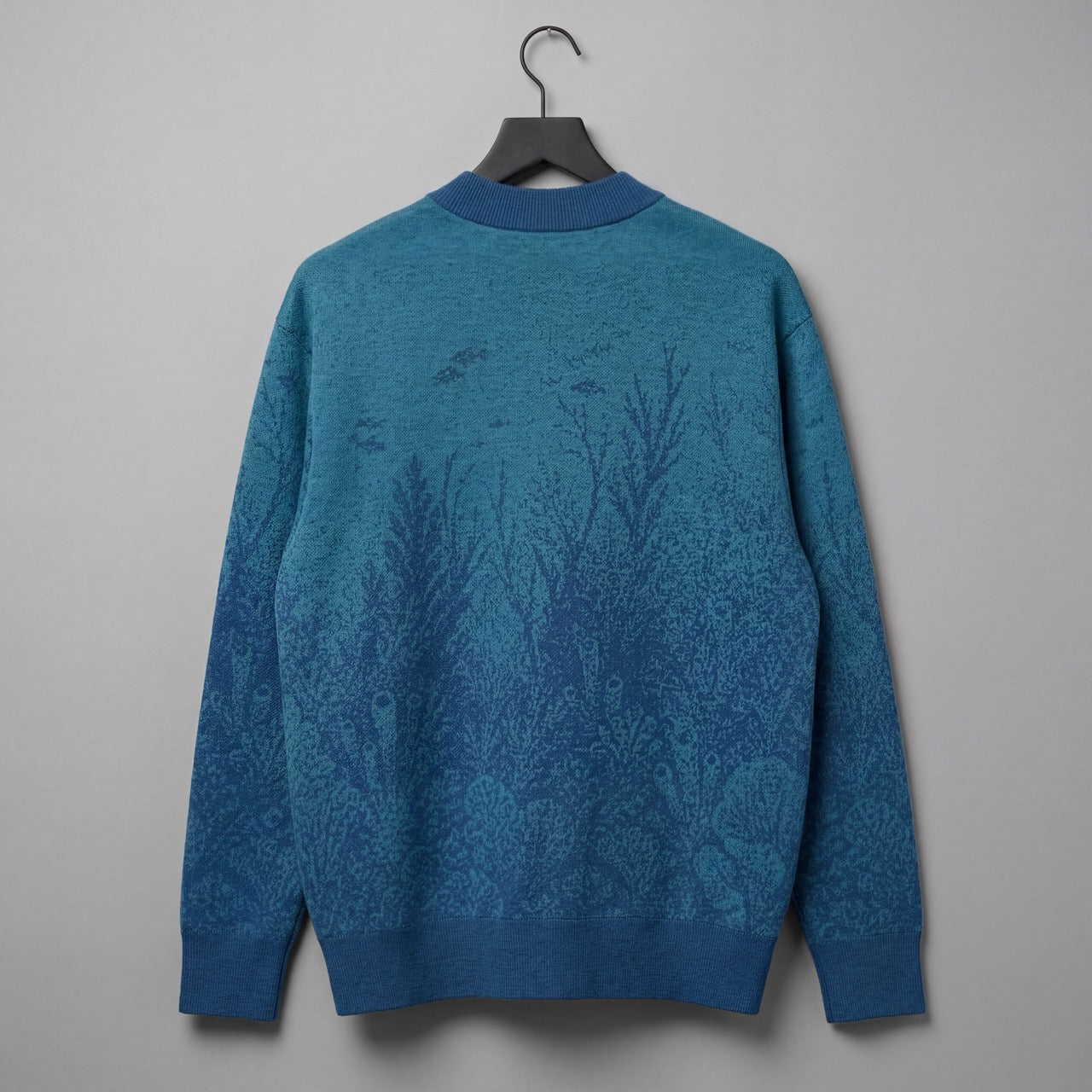 Blue gradient knit cardigan with embedded underwater pattern and ribbed trim