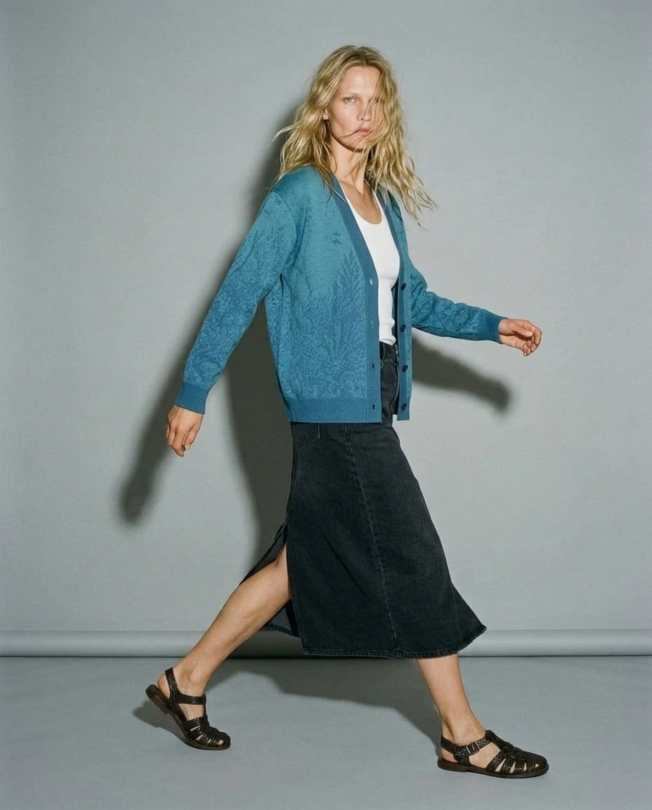 Blue organic print cardigan styled over white top and denim skirt